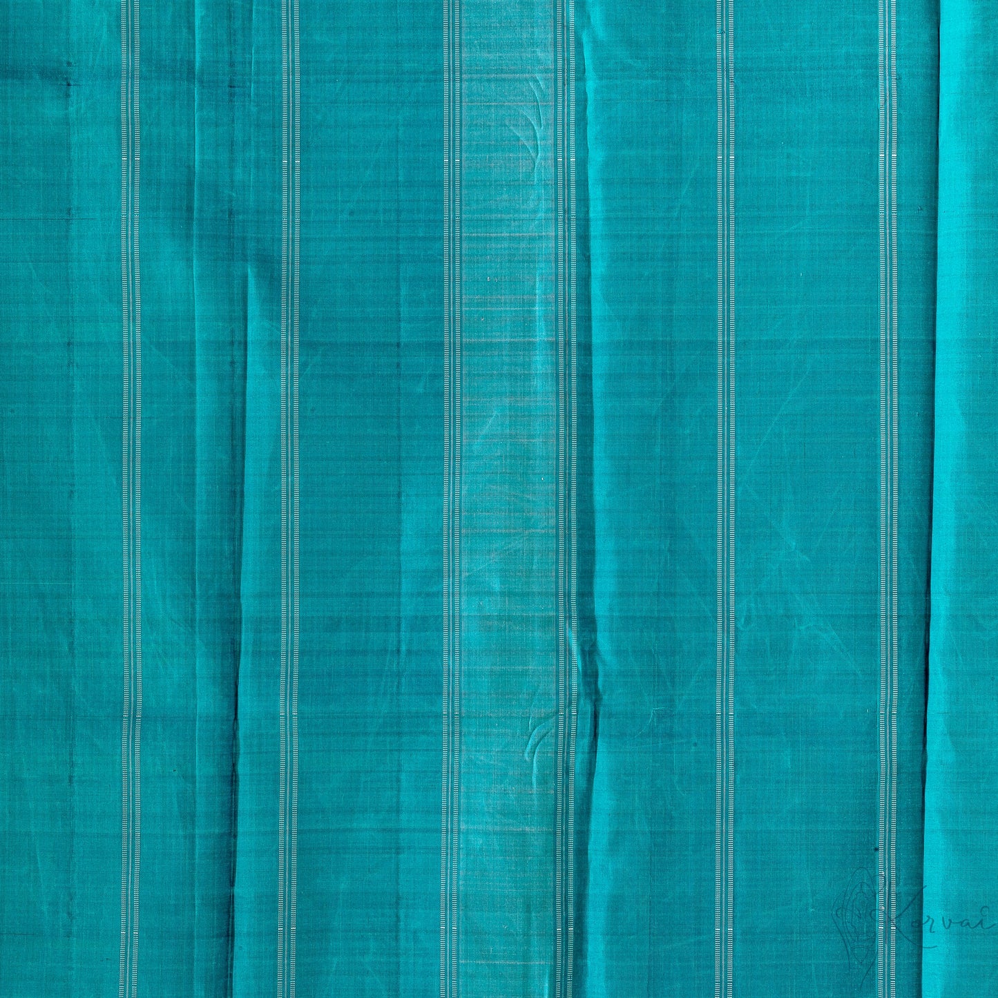 Closer view of teal pallu with white stripes.