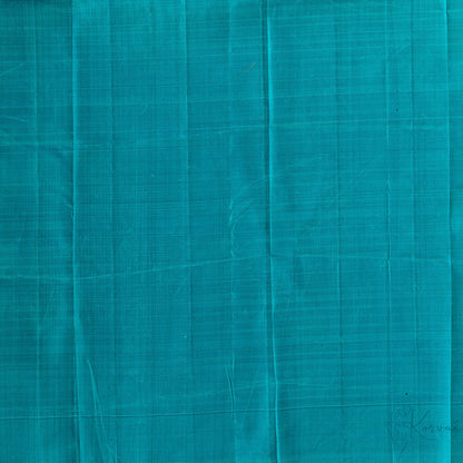 Closer view of teal plain blouse fabric.