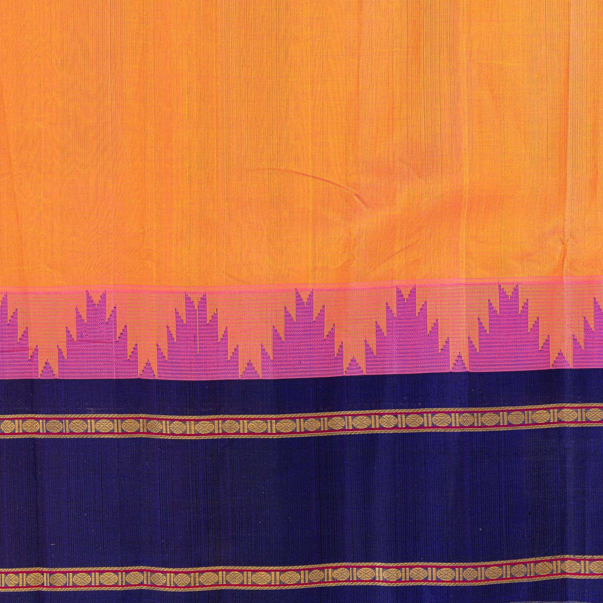 Closer view of orange silk cotton body with pink korvai temple motifs and dark blue border.