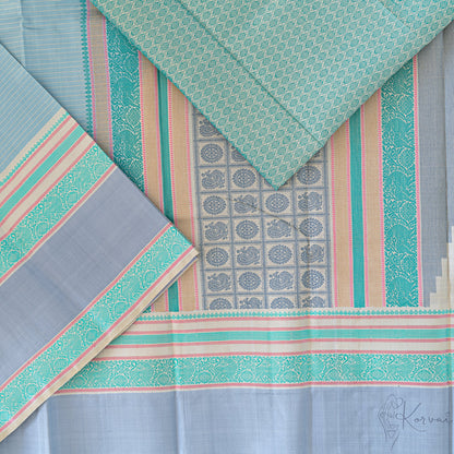 Steel grey Kanjivaram soft silk saree with teal double border and teal pallu.