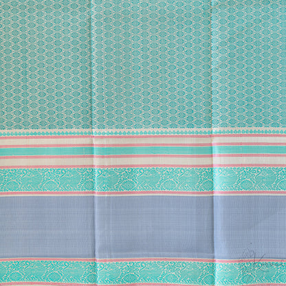 Closer view of the blouse fabric with teal double border and green jaquard design.