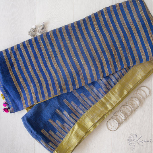 Dark blue linen saree with gold colourborder with the pallu facing up.