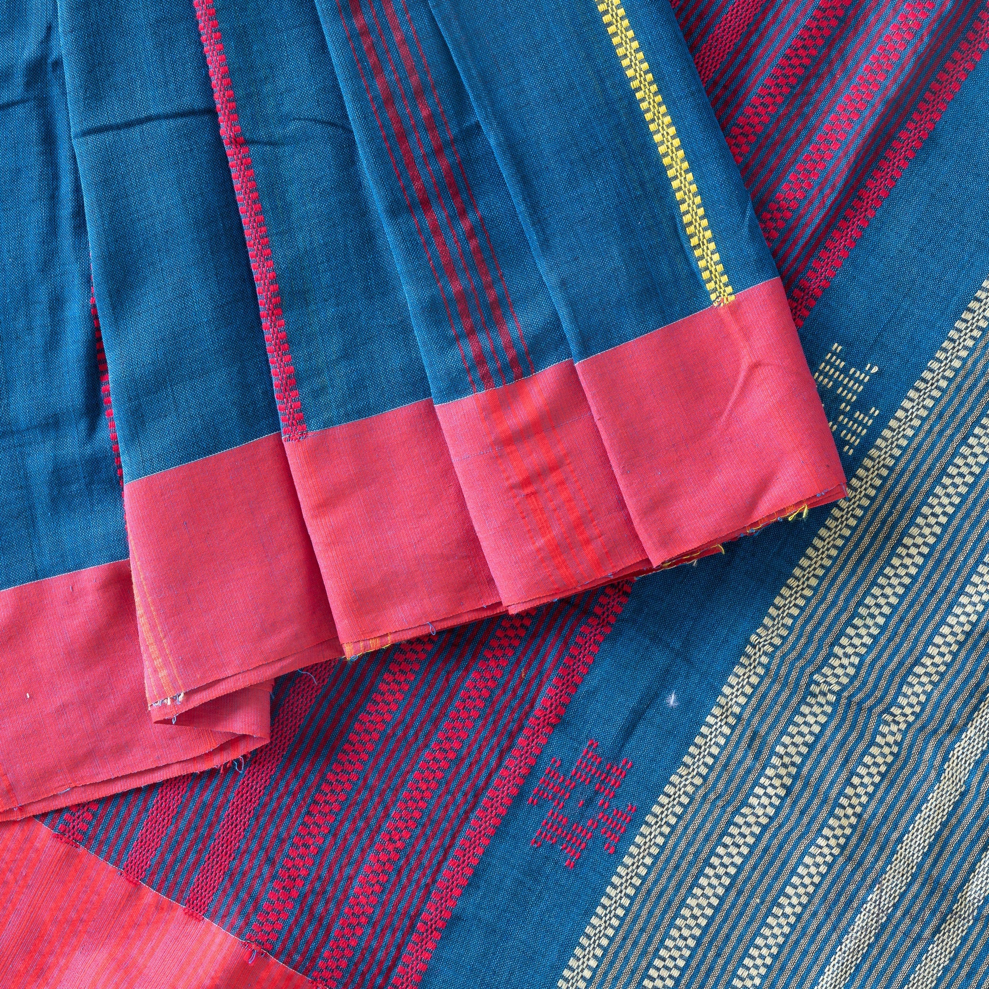 Top view of dark blue kadhi cotton saree with red border and red embroidery.