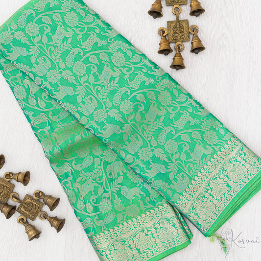 Green Kanjivaram soft silk saree with forest animals and birds motifs through the body.