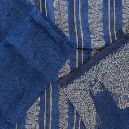 Top view of blue linen saree with cream embroidery on pallu along with blouse fabric that is blue in colour.