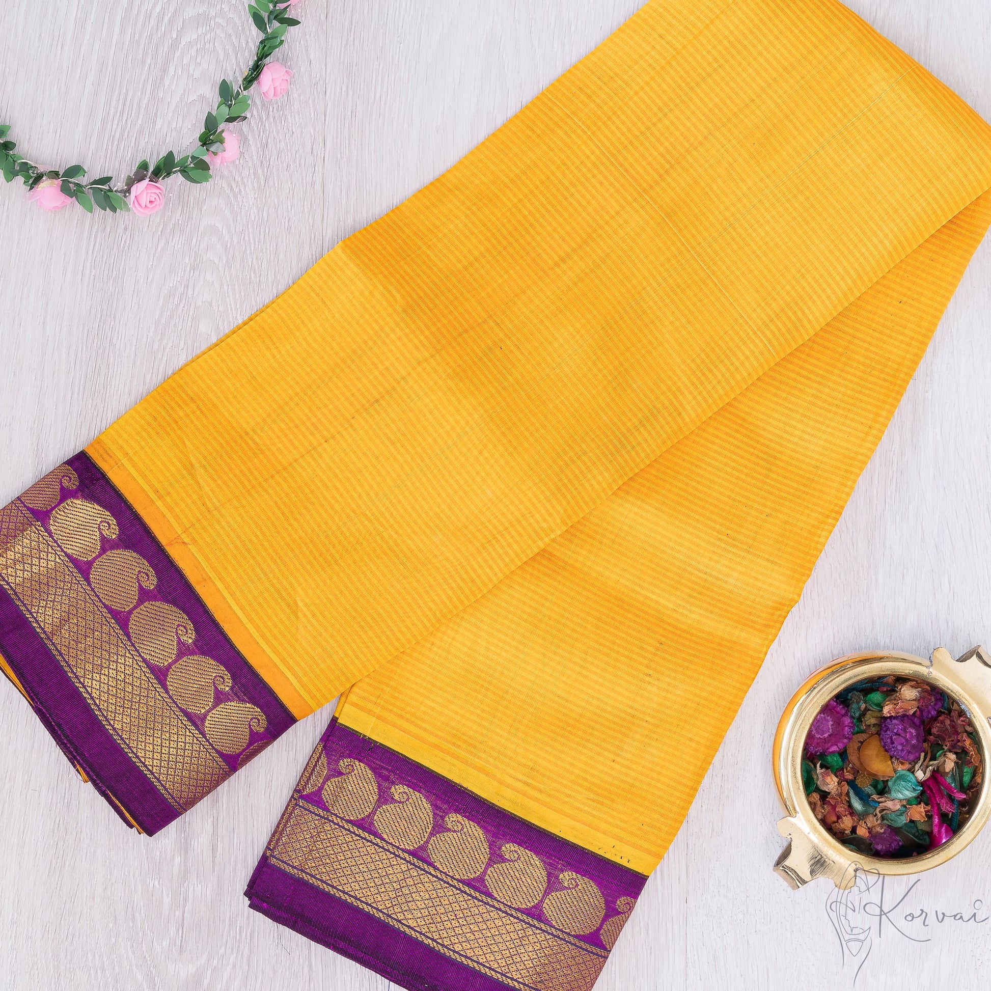 Yellow silk cotton with purple border and mango motifs.