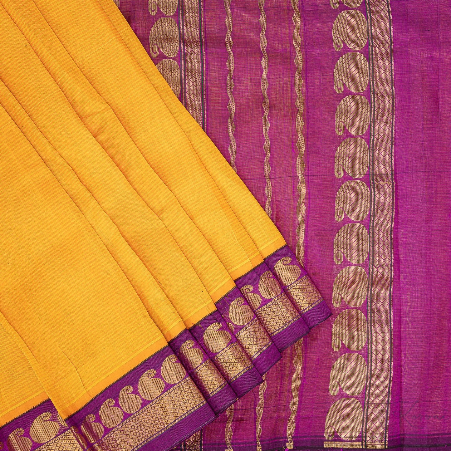 Yellow silk cotton saree with closer view of purple pallu that has intricate gold zari work.