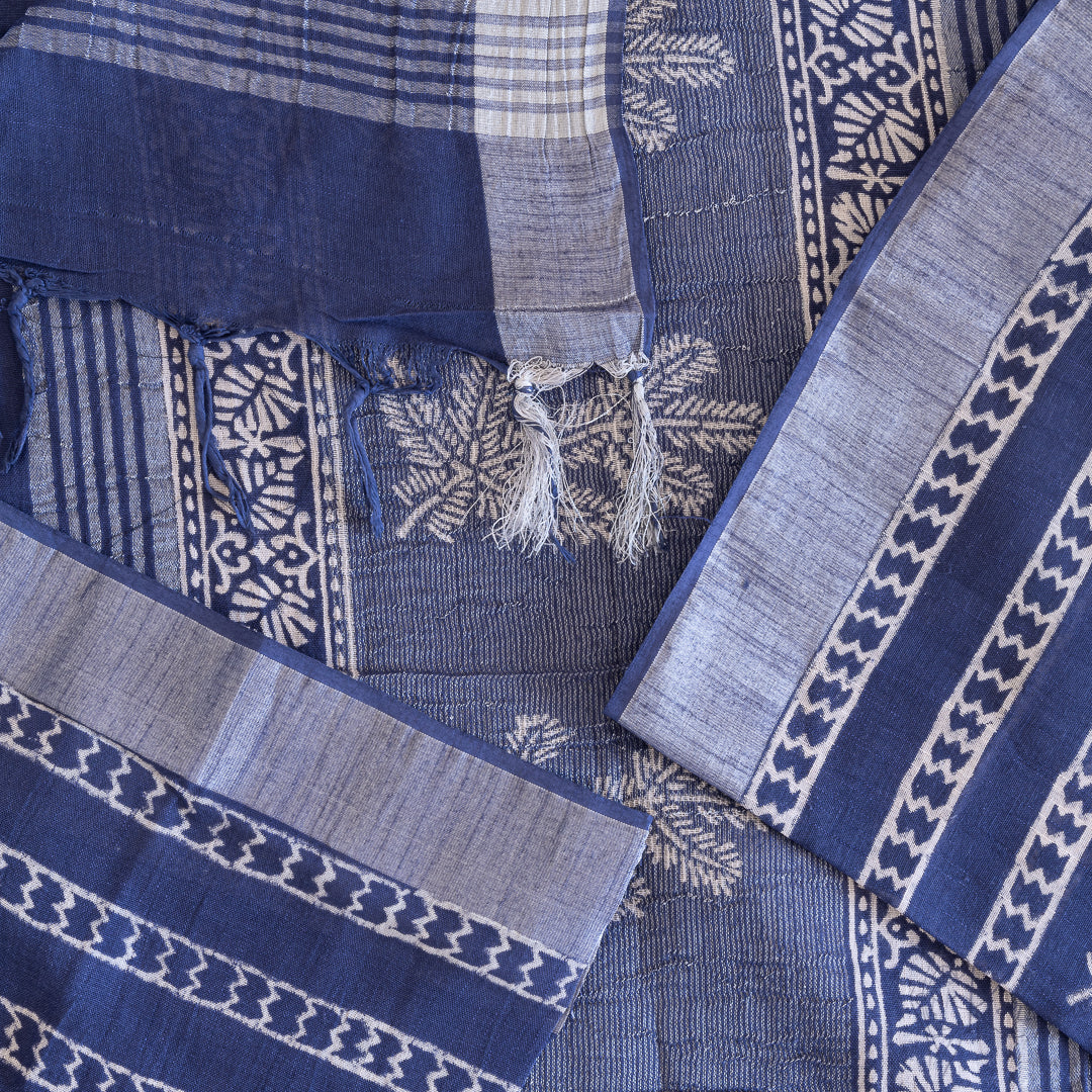 Blue cotton saree with hand block prints in white along with blouse fabric in the same material.