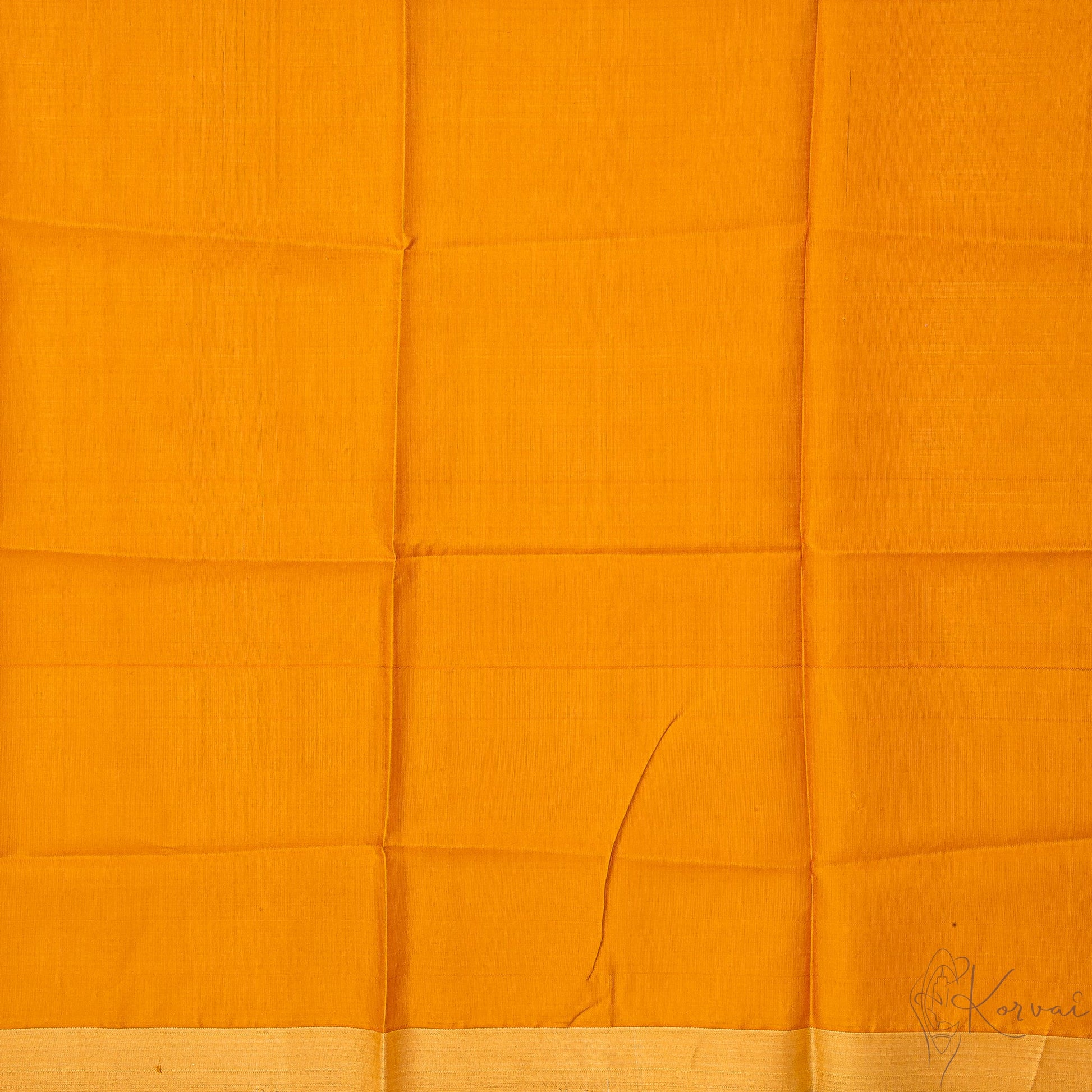 Closer view of mustard blouse fabric.