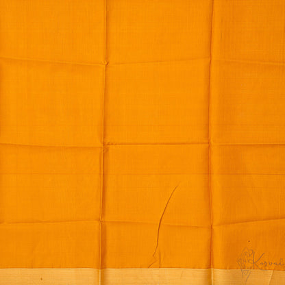 Closer view of mustard blouse fabric.