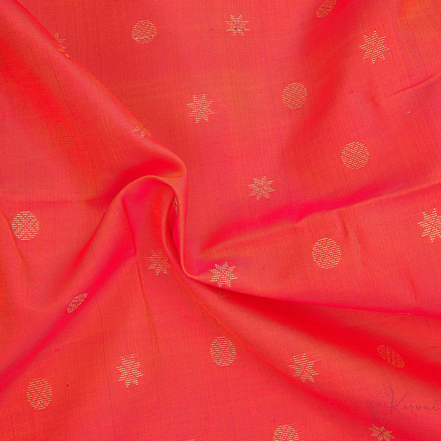 Closer view of pinkish red body with circle and star motifs and mustard pallu.